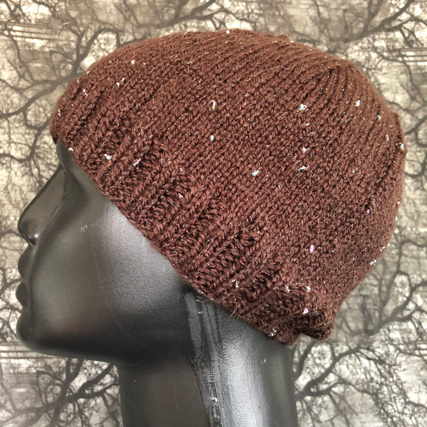 Side view of a knit hat on a mannequin head. The hat is brown with metallic flecks of blue and white.